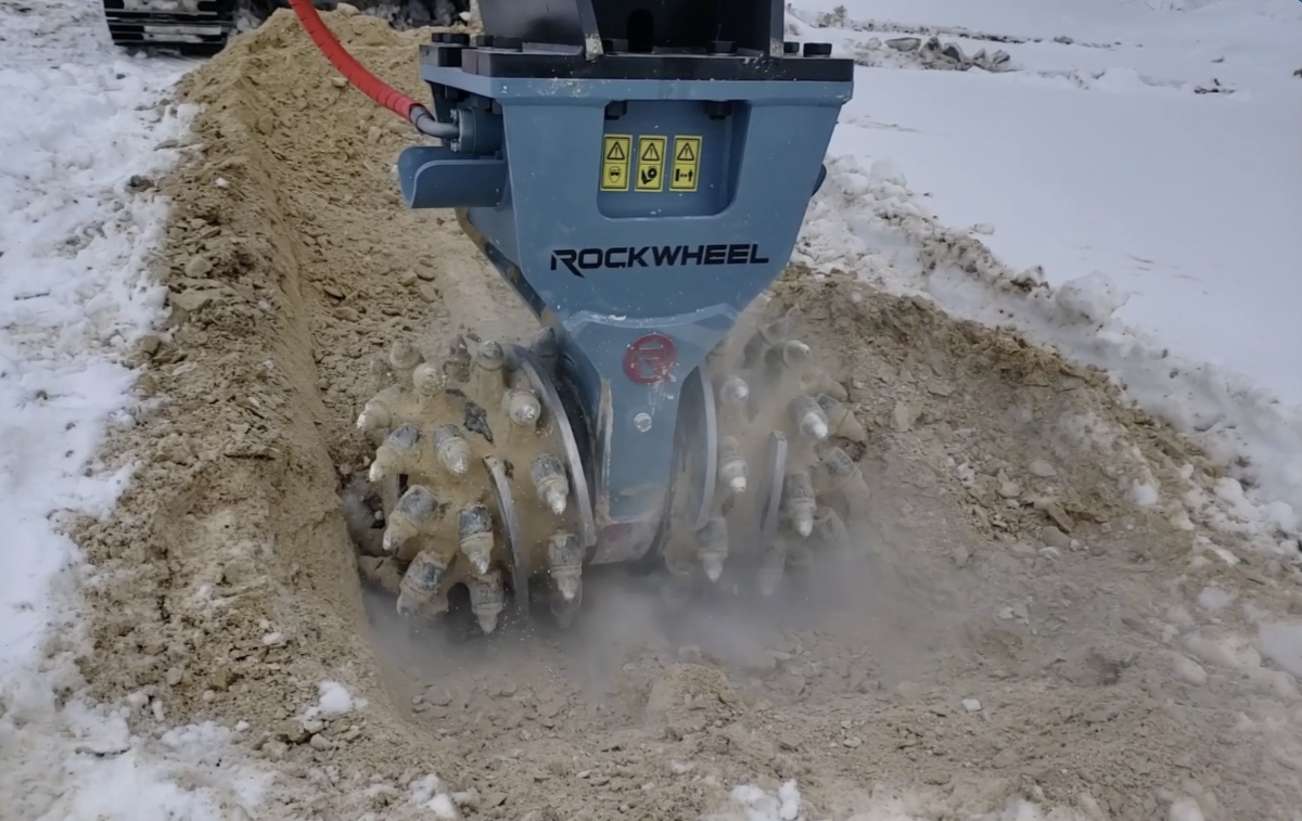 Rockwheel drum cutter grinding rock during trenching.